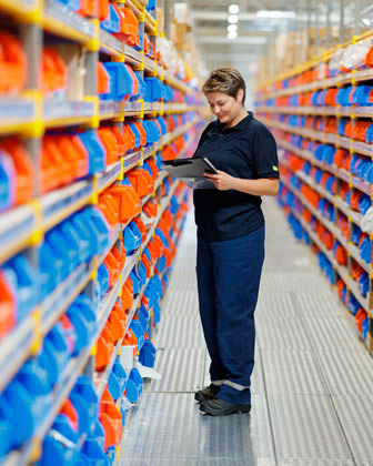 Employee checking stock in warehouse