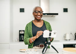women in kitchen making video call